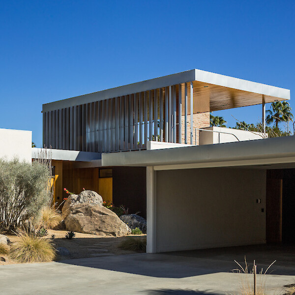 Front view of the Kaufmann Desert House with desert landscape and blue sky