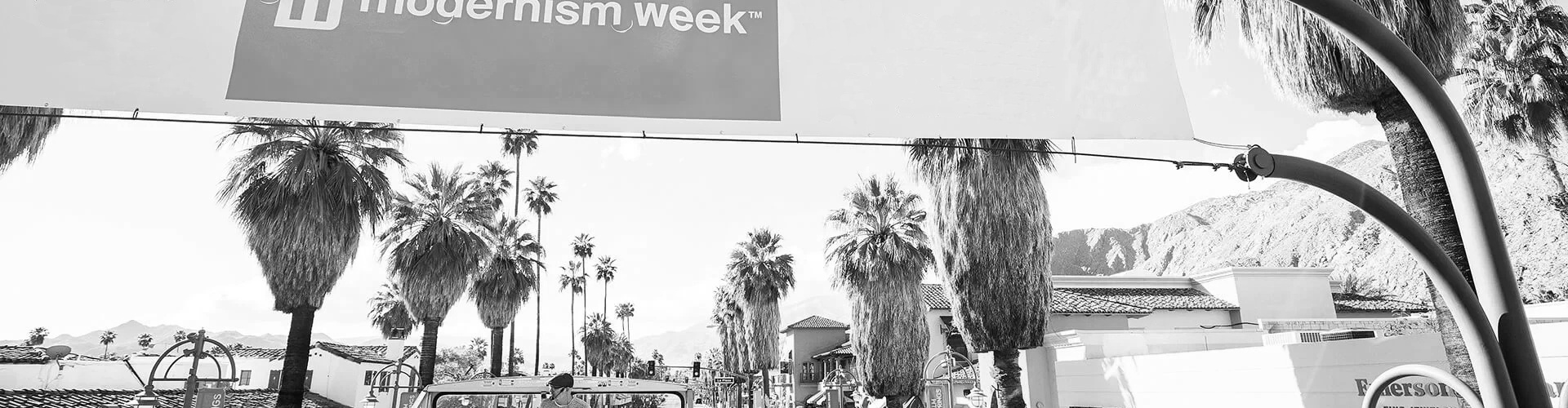 South Palm Canyond Drive in Palm Springs, CA with palm trees and Modernism Week banner